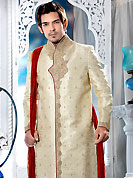 Today fashion is really about sensuality which can be seen in this creation. This cream sherwani embellished with sequins, beads,  zardosi, sawrovski, stone and patch work. The beautiful heavy embroidery on front border, collar, back and cuffs made it awesome and gives you stylish and attractive look to others. Contrasting churidar is enhanced your personality. This sherwani made with jacquard fabric. Accessories shown in the image is just for photography purpose. Slight Color variations are possible due to differing screen and photograph resolutions.