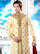 Make your collection more attractive with this dazzling dress. This cream elegant sherwani designed with all over resham, cutdana, beads, stone and patch work. The beautiful heavy embroidery on front border, collar, back and cuffs made it awesome and gives you stylish and attractive look to others. Contrasting churidar is enhanced your personality. This sherwani made with jacquard fabric. Accessories shown in the image is just for photography purpose. Slight Color variations are possible due to differing screen and photograph resolutions.