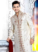Make your collection more attractive with this dazzling dress. This off white elegant sherwani designed with all over stone, cutdana, beads, zarkan, broches, stone and patch work. The beautiful embroidery on front border, collar, back and cuffs made it awesome and gives you stylish and attractive look to others. Contrasting churidar is enhanced your personality. This sherwani made with brocade fabric. Accessories shown in the image is just for photography purpose. Slight Color variations are possible due to differing screen and photograph resolutions.