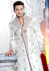 Today fashion is really about sensuality which can be seen in this creation. This off white elegant sherwani designed with all over beads, resham, zarkan, stone and patch work. The beautiful embroidery on front border, collar, back and cuffs made it awesome and gives you stylish and attractive look to others. Contrasting churidar is enhanced your personality. This sherwani made with brocade fabric. Accessories shown in the image is just for photography purpose. Slight Color variations are possible due to differing screen and photograph resolutions.