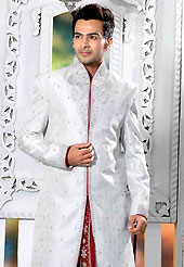 Today fashion is really about sensuality which can be seen in this creation. This light grey elegant sherwani designed with all over beads, zarkan, zardosi, stone and patch work. The beautiful heavy embroidery on front border, collar, back and cuffs made it awesome and gives you stylish and attractive look to others. Contrasting dhoti is enhanced your personality. This sherwani made with jacquard fabric. Accessories shown in the image is just for photography purpose. Slight Color variations are possible due to differing screen and photograph resolutions.