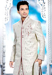 Make your collection more attractive with this dazzling sherwani. This off white elegant sherwani designed with all over beads, zarkan, zardosi, stone and patch work. The beautiful heavy embroidery on front border, collar, back and cuffs made it awesome and gives you stylish and attractive look to others. Contrasting dhoti is enhanced your personality. This sherwani made with jacquard fabric. Accessories shown in the image is just for photography purpose. Slight Color variations are possible due to differing screen and photograph resolutions.