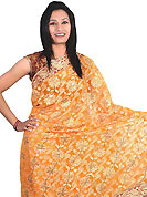 Take the fashion industry by storm in this beautiful embroidered saree. This light orange saree is beautifully designed with extensive embroidery and patch work. Embroidery is done with resham, zari and stone work in form of floral motifs. This fabulous party wear saree is specially crafted for your stunning and gorgeous look. This beautiful drape is crafted with net fabric. Matching blouse come along with this saree. Slight color variations are possible due to differing screen and photograph resolution.
