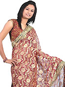 Embroidered sarees are the best choice for a girl to enhance her feminine look. This maroon saree is beautifully designed with extensive embroidery and patch work. Embroidery is done with resham, zari, sequins and stone work in form of floral motifs. This fabulous party wear saree is specially crafted for your stunning and gorgeous look. This beautiful drape is crafted with net fabric. Matching blouse come along with this saree. Slight color variations are possible due to differing screen and photograph resolution.