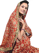 Outfit is a novel ways of getting yourself noticed. This red saree is beautifully designed with extensive embroidery and patch work. Embroidery is done with resham, zari, stone and beads work in form of floral motifs. This fabulous party wear saree is specially crafted for your stunning and gorgeous look. This beautiful drape is crafted with net fabric. Matching blouse come along with this saree. Slight color variations are possible due to differing screen and photograph resolution.