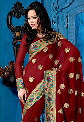 An occasion wear perfect is ready to rock you. This deep maroon saree is nicely designed with embroidered border and patch. Embroidery is done with resham and zari work in form of floral motifs. This saree gives you a modern and different look in fabulous style. This beautiful drape is crafted with faux georgette fabric. Matching blouse is available with this saree. Slight color variations are possible due to differing screen and photograph resolution.