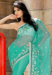 Take a look on the changing fashion of the season. This aqua green saree is beautifully designed with extensive floral embroidered border and patch work. Embroidery is done with resham, zari and stone work. Embroidery work is highlighting the beauty of the saree. This fabulous party wear saree is specially crafted for your stunning and gorgeous look. This beautiful drape is crafted with chiffon fabric. Matching blouse is available with this saree. Slight Color variations are possible due to differing screen and photograph resolutions.