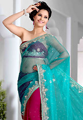 A desire that evokes a sense of belonging with a striking details. This aqua and deep magenta saree is nicely designed with embroidered and patch work in fabulous style. Embroidery is done with sequins, stone, cutdana, kasab and cut moti work in form of floral motifs. Beautiful embroidery work on saree make attractive to impress all. This saree gives you a modern and different look in fabulous style. This beautiful drape is crafted with half half net and jacquard fabric. Matching blouse is available with this saree. Slight color variations are possible due to differing screen and photograph resolution.