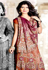 You can be sure that ethnic fashions selections of clothing are taken from the latest trend in today’s fashion. This deep magenta and rust shimmer faux georgette lehenga style saree is nicely designed with embroidered and patch work in fabulous style. Embroidery is done with resham, zari, sequins, stone, cutdana, kasab and cut work in form of floral motifs. Beautiful embroidery work on saree make attractive to impress all. This saree gives you a modern and different look in fabulous style. Matching blouse is available with this saree. Slight color variations are possible due to differing screen and photograph resolution.