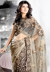 You can be sure that ethnic fashions selections of clothing are taken from the latest trend in today’s fashion. This beige and black half half net and brocade saree is nicely designed with embroidered and patch work in fabulous style. Embroidery is done with self weaving, resham, zari, sequins, stone, kasab and cutdana work in form of floral motifs. Beautiful embroidery work on saree make attractive to impress all. This saree gives you a modern and different look in fabulous style. Matching blouse is available with this saree. Slight color variations are possible due to differing screen and photograph resolution.