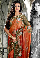 It is color this season and bright shaded suits are really something that is totally in vogue. This shaded rust shimmer faux georgete saree is nicely designed with embroidered and net patch work in fabulous style. Embroidery is done with resham, zari, sequins, stone, kasab and cutdana work in form of floral motifs. Beautiful embroidery work on saree make attractive to impress all. This saree gives you a modern and different look in fabulous style. Matching blouse is available with this saree. Slight color variations are possible due to differing screen and photograph resolution.