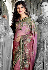 It is color this season and bright shaded suits are really something that is totally in vogue. This shaded pink shimmer faux georgete saree is nicely designed with embroidered and net patch work in fabulous style. Embroidery is done with resham, zari, sequins, stone, kasab and cutdana work in form of floral motifs. Beautiful embroidery work on saree make attractive to impress all. This saree gives you a modern and different look in fabulous style. Matching blouse is available with this saree. Slight color variations are possible due to differing screen and photograph resolution.