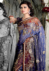 Get ready to sizzle all around you by sparkling saree. This shaded navy blue shimmer faux georgete saree is nicely designed with embroidered and net patch work in fabulous style. Embroidery is done with resham, zari, sequins, stone, kasab and cutdana work in form of floral motifs. Beautiful embroidery work on saree make attractive to impress all. This saree gives you a modern and different look in fabulous style. Matching blouse is available with this saree. Slight color variations are possible due to differing screen and photograph resolution.