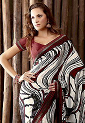 Let your personality articulate for you with this amazing printed saree. This off white and brown crepe saree is simply designed with abstract print and patch work. This beautiful saree is used for casual porpose which gives you a singular and dissimilar look. Color blend of this saree is nice. Matching blouse is available with this saree. Slight color variations possible due to differing screen and photograph resolution.