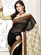 Keep the interest with this designer embroidery saree. This black and cream georgette and banarasi silk saree is nicely designed with floral print and embroidered patch work in fabulous style. Embroidery is done with zari, applique and sequins work in form of floral motifs. Beautiful patch border on saree make attractive to impress all. This saree gives you a modern and different look in fabulous style. Matching blouse is available with this saree. Slight color variations are possible due to differing screen and photograph resolution.