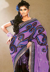Exuberant colour and exotic patterns for the gorgeous you. This purple and black georgette saree is nicely designed with floral print, embroidered patch work in fabulous style. Embroidery is done with resham, zari and sequins work in form of floral motifs. Beautiful embroidery patch work and border on saree make attractive to impress all. This saree gives you a modern and different look in fabulous style. Matching blouse is available with this saree. Slight color variations are possible due to differing screen and photograph resolution.