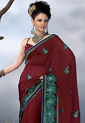 It is color this season and bright shaded suits are really something that is totally in vogue. This maroon chiffon saree have beautiful embroidery patch work which is embellished with resham, zari and stone work in floral motifs. Fabulous designed embroidery gives you an ethnic look and increasing your beauty. Matching blouse is available. Slight Color variations are possible due to differing screen and photograph resolutions.