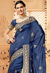 Ultimate collection of embroidery sarees with fabulous style. This dark blue banarasi silk saree have beautiful embroidery patch work which is embellished with zari work in floral motifs. Fabulous designed embroidery gives you an ethnic look and increasing your beauty. Matching blouse is available. Slight Color variations are possible due to differing screen and photograph resolutions.