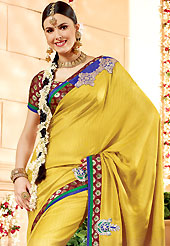 The glamorous silhouette to meet your most dire fashion needs. This golden yellow banarasi silk saree have beautiful embroidery patch work which is embellished with resham, zari and antique zardosi work. Fabulous designed embroidery gives you an ethnic look and increasing your beauty. Contrasting maroon blouse is available. Slight Color variations are possible due to differing screen and photograph resolutions.