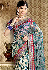 Era with extension in fashion, style, Grace and elegance have developed grand love affair with this ethnical wear. This cream net and viscose saree is nicely designed with embroidered and silk patch work is done with kundan, kasab, resham, cutdana, sequins and stone work. Embroidery work is highlighting the beauty of the saree. Saree gives you a singular and dissimilar look. Contrasting purple blouse is available. Slight color variations are possible due to differing screen and photograph resolution.