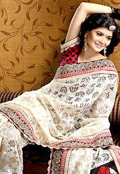Attract all attentions with this embroidered saree. This off white jute net saree is nicely designed with embroidered and silk patch work is done with kundan, kasab, zari, stone, pull motti work. Embroidery work is highlighting the beauty of the saree. Saree gives you a singular and dissimilar look. Contrasting red and black blouse is available. Slight color variations are possible due to differing screen and photograph resolution.