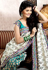 Keep the interest with this designer embroidery saree. This off white and turquoise green banarasi silk saree is nicely designed with embroidered and brocede patch work is done with resham, kasab, kundan, cutdana, sequins and stone work. Embroidery work is highlighting the beauty of the saree. Saree gives you a singular and dissimilar look. Matching blouse is available. Slight color variations are possible due to differing screen and photograph resolution.