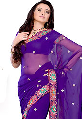 Look stunning rich with dark shades and floral patterns. This light violet georgette saree have beautifully embellished with resham, sequins and patch border work. This saree gives you a modern and different look in fabulous style. Matching blouse is available. Slight Color variations are possible due to differing screen and photograph resolutions.