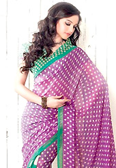 Make a trendy look with this classic printed saree. This light violet and green faux georgette saree is nicely designed with polka dots and geometric print work in fabulous style. Saree gives you a singular and dissimilar look. Matching blouse is available. Slight color variations are possible due to differing screen and photograph resolution.