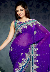 Dreamy variation on shape and forms compliment your style with tradition. This violet faux chiffon saree is nicely designed with embroidered patch work is done with zari, sequins, stone and cutdana work. This saree gives you a modern and different look in fabulous style. Matching blouse is available with this saree. Slight color variations are possible due to differing screen and photograph resolution.