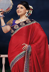An occasion wear perfect is ready to rock you. This red satin chiffon saree is nicely designed with embroidered and patch border work is done with zari and stone work. Saree gives you a singular and dissimilar look. Contrasting blue dupion and brocade blouse is available. Slight color variations are possible due to differing screen and photograph resolution.