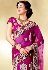 Embroidered sarees are the best choice for a girl to enhance her feminine look. This dark magenta net lehenga style saree is nicely designed with embroidered patch work is done with resham, zari, stone, beads and cutbeads work. Saree gives you a singular and dissimilar look. Matching blouse is available. Slight color variations are possible due to differing screen and photograph resolution.