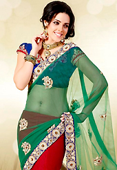 Make a trendy look with this classic embroidered saree. This green and red net lehenga style saree is nicely designed with embroidered patch work is done with zari, stone, beads and bullion work. Saree gives you a singular and dissimilar look. Contrasting blue blouse is available. Slight color variations are possible due to differing screen and photograph resolution.