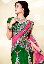 Breathtaking collection of sarees with stylish embroidery work and fabulous style. This pink, green and off white net lehenga style saree is nicely designed with embroidered patch work is done with resham, zari, stone, beads and cutbeads work. Saree gives you a singular and dissimilar look. Matching green blouse is available. Slight color variations are possible due to differing screen and photograph resolution.