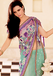 Take a look on the changing fashion of the season. This sea green and purple net lehenga style saree is nicely designed with heavy embroidered patch work is done with resham, zari, sequins, stone, beads and lace work. Beautiful embroidery patch border on saree make attractive to impress all. This saree gives you a modern and different look in fabulous style. Matching blouse is available with this saree. Slight color variations are possible due to differing screen and photograph resolution.