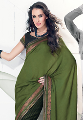 The most beautiful refinements for style and tradition. This olive green and black faux crepe saree is nicely designed with embroidered patch work is done with resham, zari and sequins work. This saree gives you a modern and different look in fabulous style. Matching black blouse is available. Slight color variations are possible due to differing screen and photograph resolution.