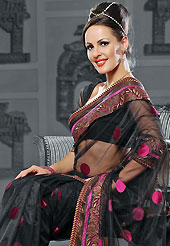 A desire that evokes a sense of belonging with a striking details. This black net saree is nicely designed with embroidered patch work is done with resham and zari work. Beautiful embroidery work on saree make attractive to impress all. This saree gives you a modern and different look in fabulous style. Matching blouse is available. Slight color variations are possible due to differing screen and photograph resolution.