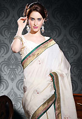 An occasion wear perfect is ready to rock you. This light cream art silk saree is nicely designed with embroidered patch work is done with resham, zari and sequins work. Beautiful embroidery work on saree make attractive to impress all. This saree gives you a modern and different look in fabulous style. Matching blouse is available. Slight color variations are possible due to differing screen and photograph resolution.