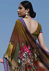 An occasion wear perfect is ready to rock you. This beautiful dark olive green and brown faux georgette saree is nicely designed with floral, traditional art print and graceful patch border. Beautiful print work on saree make attractive to impress all. It will enhance your personality and gives you a singular look. Matching blouse is available with this saree. Slight color variations are due to differing screen and photography resolution.