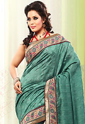 The most beautiful refinements for style and tradition. This teal green bhagalpuri jacquard silk saree is nicely designed with embroidered patch work is done with resham, zari and stone work. Saree gives you a singular and dissimilar look. Contrasting red blouse is available. Slight color variations are possible due to differing screen and photograph resolution.