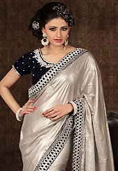 Ultimate collection of embroidered sarees with fabulous style. This light grey shimmer georgette saree have beautiful embroidery patch work which is embellished with stone and cutbeads work. Fabulous designed embroidery gives you an ethnic look and increasing your beauty. Contrasting black blouse is available. Slight Color variations are possible due to differing screen and photograph resolutions.