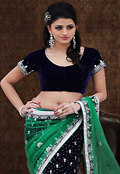 Keep the interest with this designer embroidery saree. This green and dark navy blue net and velvet lehenga style saree have beautiful embroidery patch work which is embellished with stone and beads work. Fabulous designed embroidery gives you an ethnic look and increasing your beauty. Matching dark navy blue velvet blouse is available. Slight Color variations are possible due to differing screen and photograph resolutions.