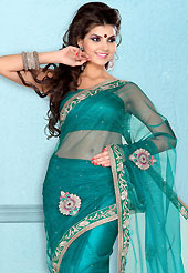Era with extension in fashion, style, Grace and elegance have developed grand love affair with this ethnical wear. This teal green net saree is nicely designed with embroidered patch work is done with resham, zari, stone and lace work. Beautiful embroidery work on saree make attractive to impress all. This saree gives you a modern and different look in fabulous style. Matching blouse is available. Slight color variations are possible due to differing screen and photograph resolution.