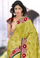 Exquisite combination of color, fabric can be seen here. This light olive green art silk saree is nicely designed with embroidery and velvet patch work is done with resham, zari, stone and lace work. Saree gives you a singular and dissimilar look. Contrasting maroon blouse is available. Slight color variations are possible due to differing screen and photograph resolution.