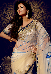 Outfit is a novel ways of getting yourself noticed. This cream net saree is nicely designed with embroidered patch work is done with resham, zari, stone, mirror and lace work. Beautiful embroidery work on saree make attractive to impress all. This saree gives you a modern and different look in fabulous style. Matching blouse is available. Slight color variations are possible due to differing screen and photograph resolution.