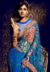 Attract all attentions with this embroidered saree. This blue net saree is nicely designed with embroidered patch work is done with resham, zari, stone and lace work. Beautiful embroidery work on saree make attractive to impress all. This saree gives you a modern and different look in fabulous style. Matching blouse is available. Slight color variations are possible due to differing screen and photograph resolution.