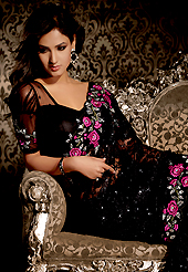 Ultimate collection of embroidered sarees with fabulous style. This black net saree is nicely designed with embroidered patch work is done with resham, sequins, stone and lace work. Beautiful embroidery work on saree make attractive to impress all. This saree gives you a modern and different look in fabulous style. Matching blouse is available. Slight color variations are possible due to differing screen and photograph resolution.
