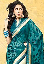 Envelope yourself in classic look with this charming saree. This teal green and off white saree is nicely designed with embroidered patch work is done with resham, zari and stone work. Saree gives you a singular and dissimilar look. Matching blouse is available. Slight color variations are possible due to differing screen and photograph resolution.