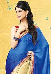 Envelope yourself in classic look with this charming saree. This blue and dark beige saree is nicely designed with embroidered patch work is done with resham, zari and lace work. Saree gives you a singular and dissimilar look. Contrasting red blouse is available. Slight color variations are possible due to differing screen and photograph resolution.