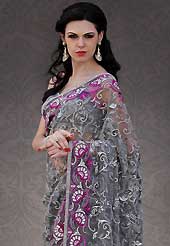 Dreamy variation on shape and forms compliment your style with tradition. This grey net saree is nicely designed with embroidered patch work is done with resham, sequins and stone work. Beautiful embroidery work on saree make attractive to impress all. This saree gives you a modern and different look in fabulous style. Matching grey and pink blouse is available. Slight color variations are possible due to differing screen and photograph resolution.