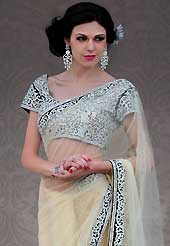 Era with extension in fashion, style, Grace and elegance have developed grand love affair with this ethnical wear. This cream net saree is nicely designed with embroidery and velvet patch work is done with stone work. Beautiful embroidery work on saree make attractive to impress all. This saree gives you a modern and different look in fabulous style. Matching blouse is available. Slight color variations are possible due to differing screen and photograph resolution.